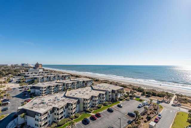 drone / aerial view featuring a water view and a view of the beach