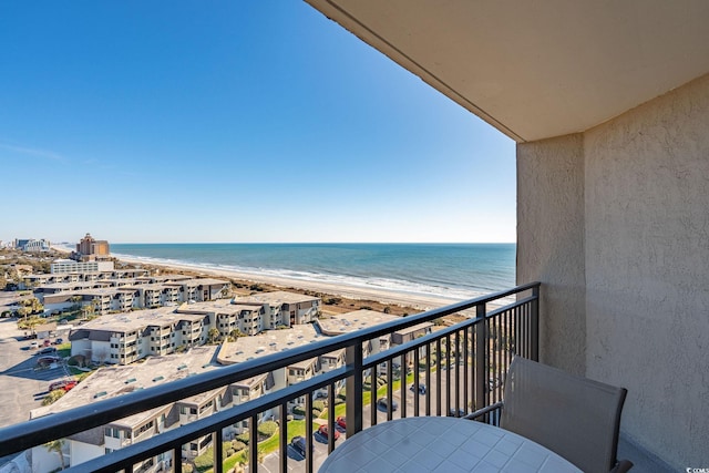 balcony featuring a water view and a view of the beach