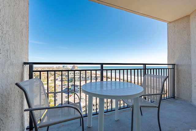 balcony featuring a water view and a view of the beach