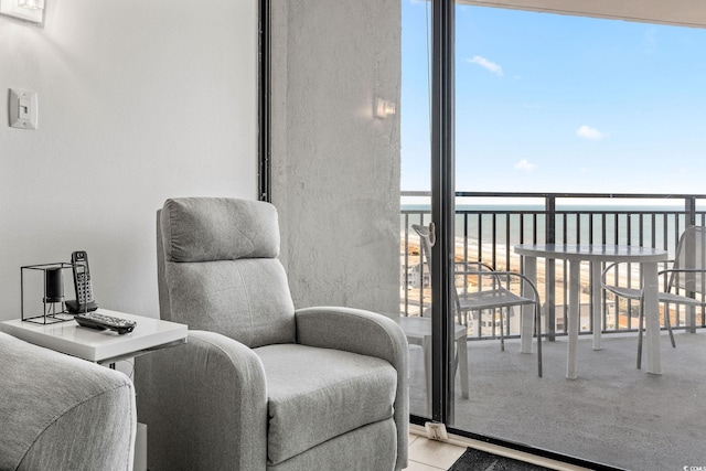 interior space with floor to ceiling windows and a water view