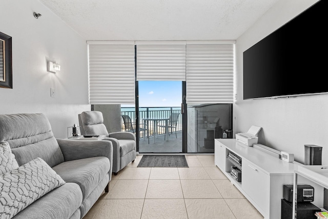 living room with light tile patterned flooring and a wall of windows