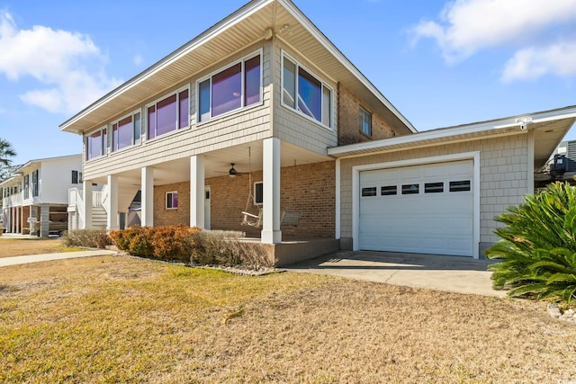 3545 Marion Ln, Murrells Inlet, SC 29576 - view of front of home featuring concrete driveway, an attached garage, brick siding, a porch, and a front lawn