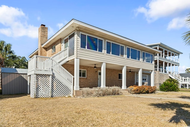 3545 Marion Ln, Murrells Inlet, SC 29576 - view of home's exterior with a chimney, stairway, brick siding, a ceiling fan, and a yard