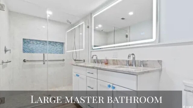 3545 Marion Ln, Murrells Inlet, SC 29576 - bathroom featuring a stall shower, double vanity, and recessed lighting