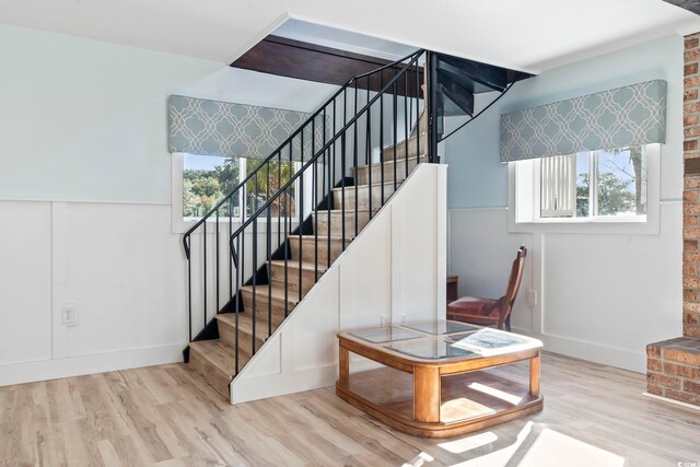 3545 Marion Ln, Murrells Inlet, SC 29576 - stairs with plenty of natural light, wood finished floors, and a wainscoted wall