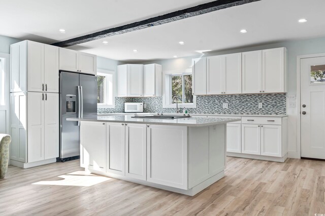 3545 Marion Ln, Murrells Inlet, SC 29576 - kitchen with stainless steel appliances, tasteful backsplash, light countertops, light wood-type flooring, and beam ceiling