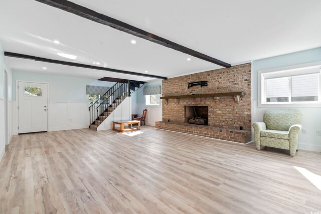3545 Marion Ln, Murrells Inlet, SC 29576 - unfurnished living room with beamed ceiling, stairway, wood finished floors, a brick fireplace, and baseboards