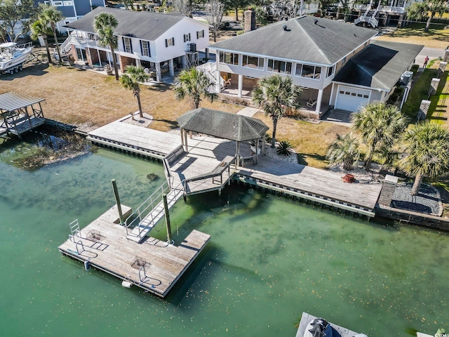 view of dock with a gazebo and a water view