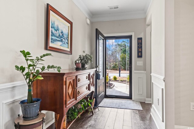 foyer entrance with dark hardwood / wood-style flooring and crown molding