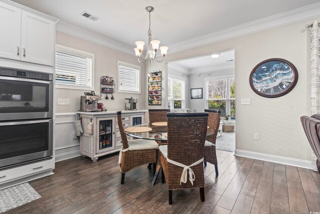 dining space with crown molding, dark hardwood / wood-style flooring, and a notable chandelier