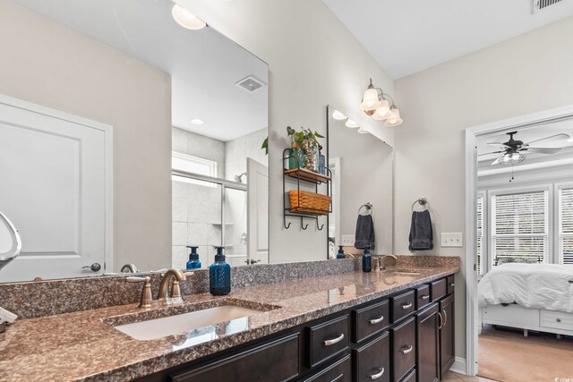 bathroom with vanity, ceiling fan, and a shower with shower door