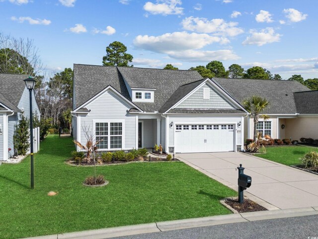 view of front of house with a garage and a front yard