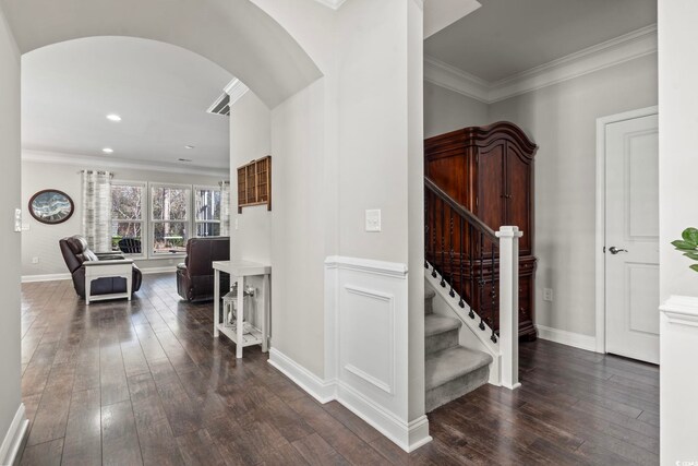 hallway with ornamental molding and dark wood-type flooring