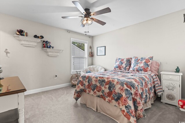 bedroom with ceiling fan and light carpet