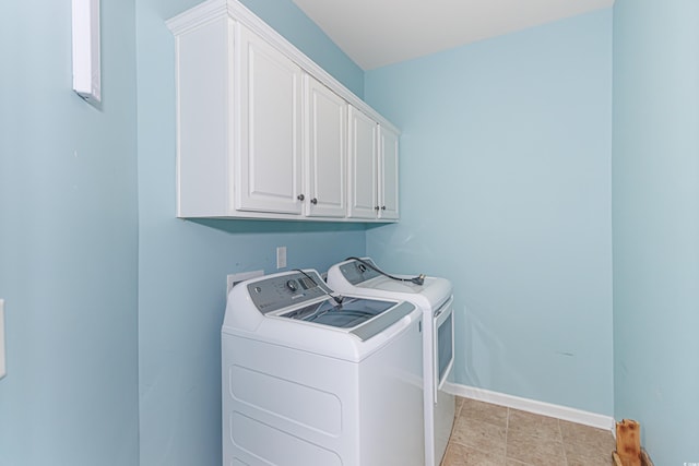 laundry room with cabinets and washing machine and clothes dryer