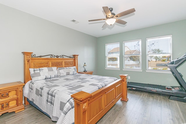 bedroom with light hardwood / wood-style floors and ceiling fan