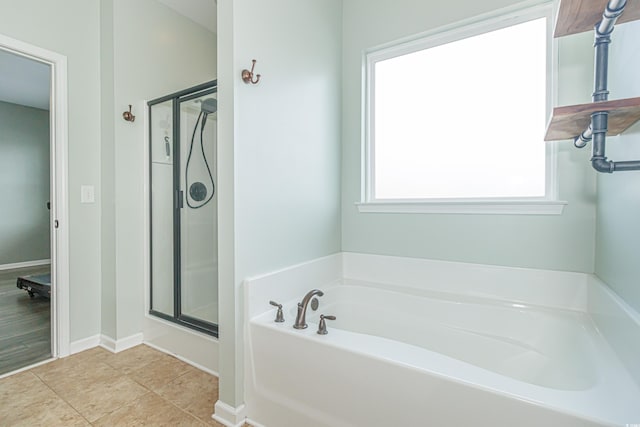 bathroom featuring tile patterned flooring and separate shower and tub