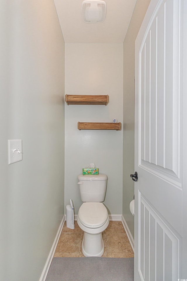 bathroom with tile patterned flooring and toilet