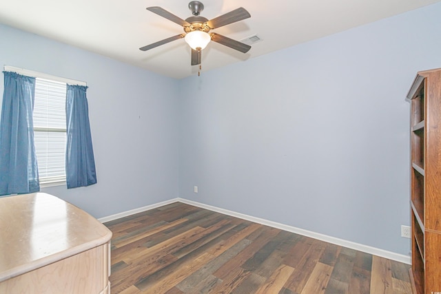 office space with dark wood-type flooring and ceiling fan