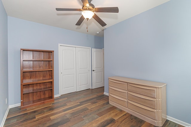 bedroom featuring a closet, dark hardwood / wood-style floors, and ceiling fan