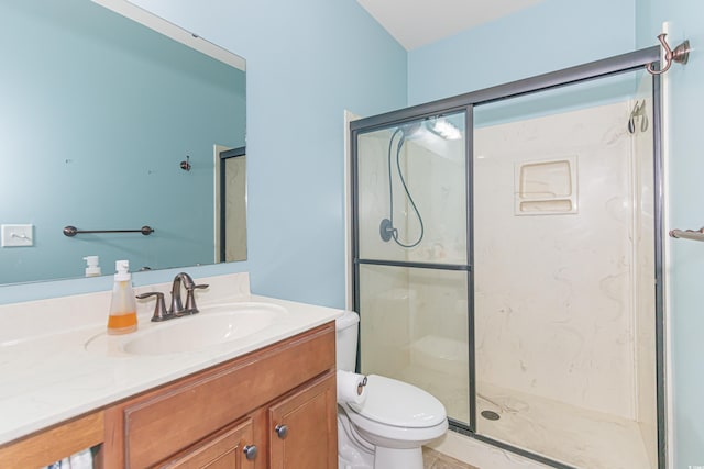 bathroom featuring vanity, an enclosed shower, and toilet