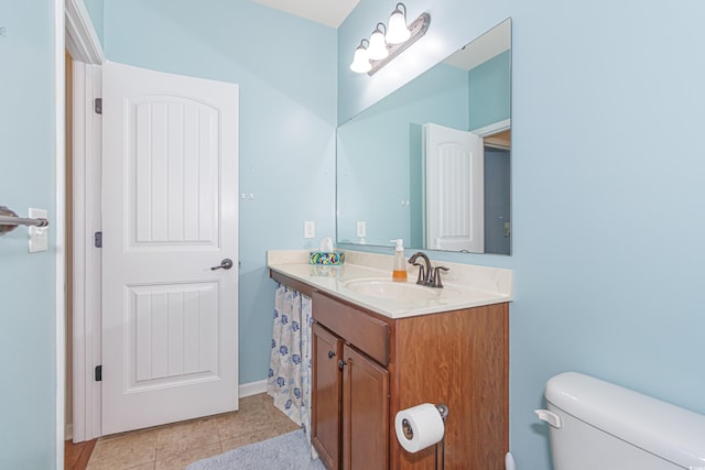 bathroom with vanity, tile patterned floors, and toilet