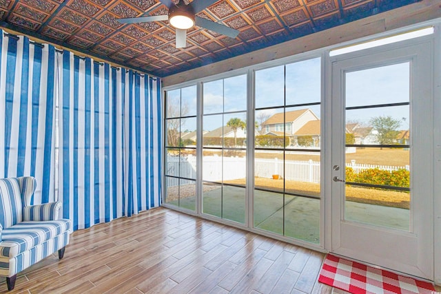 unfurnished sunroom with ceiling fan and a healthy amount of sunlight