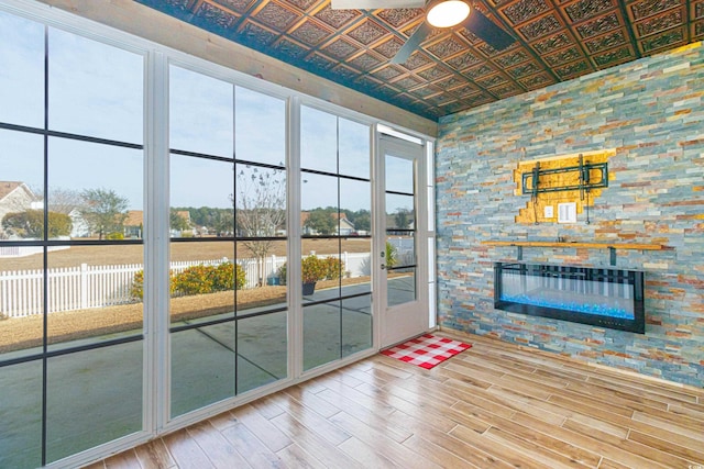 doorway to outside with a fireplace and hardwood / wood-style floors