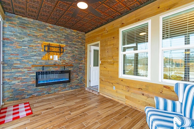 unfurnished room with a fireplace and wood walls