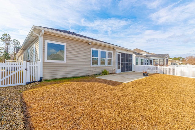 back of property featuring a yard and a patio