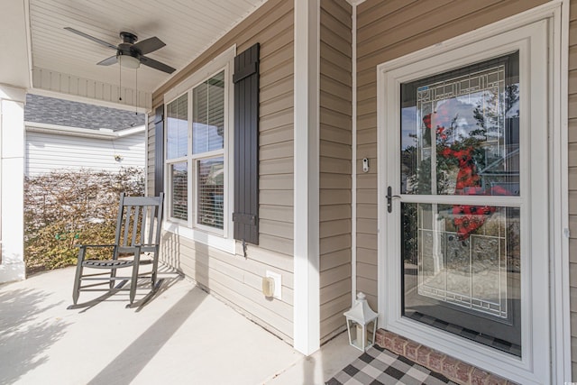 view of exterior entry with ceiling fan