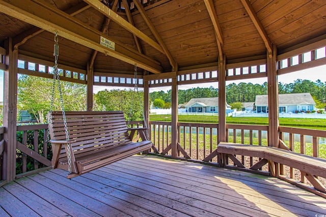 wooden terrace featuring a yard and a gazebo