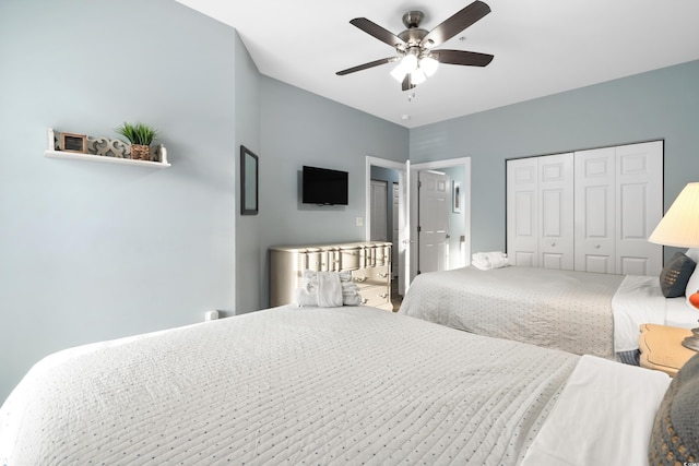 bedroom with ceiling fan and a closet