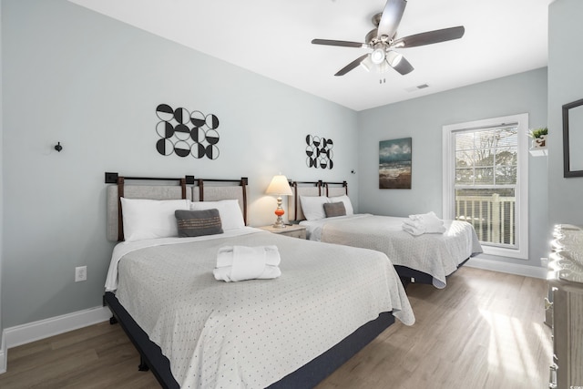 bedroom featuring hardwood / wood-style flooring and ceiling fan