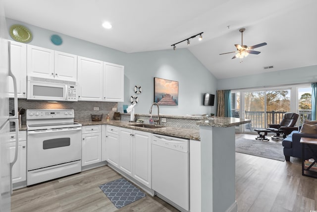 kitchen featuring sink, white cabinets, white appliances, and kitchen peninsula