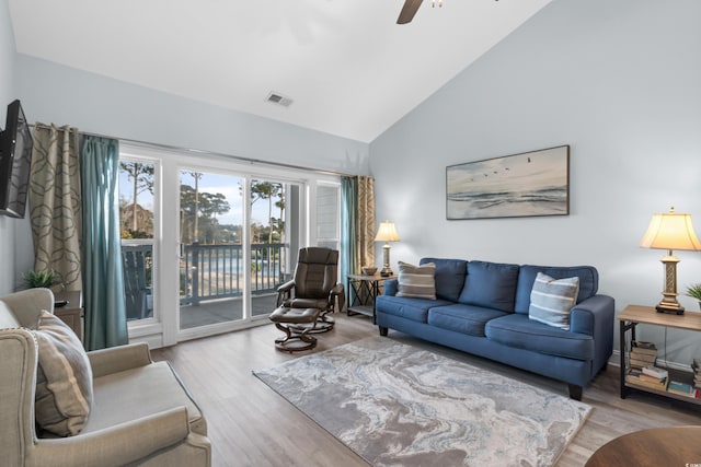 living room featuring high vaulted ceiling, light hardwood / wood-style floors, and ceiling fan