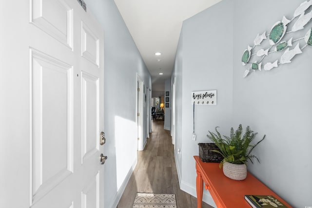 corridor with hardwood / wood-style flooring