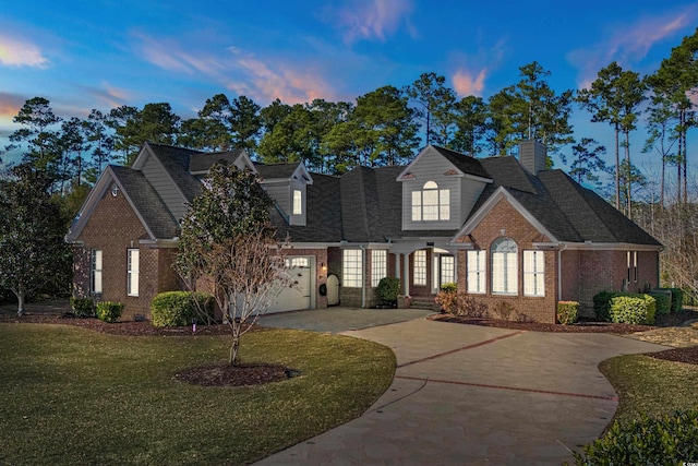 view of front of home featuring a yard and a garage