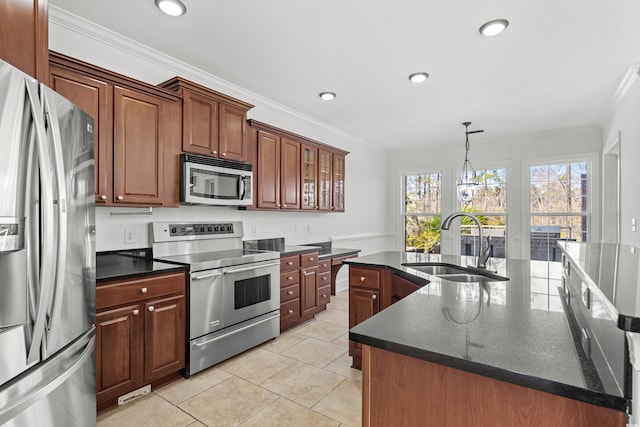 kitchen with light tile patterned flooring, appliances with stainless steel finishes, sink, crown molding, and a center island with sink