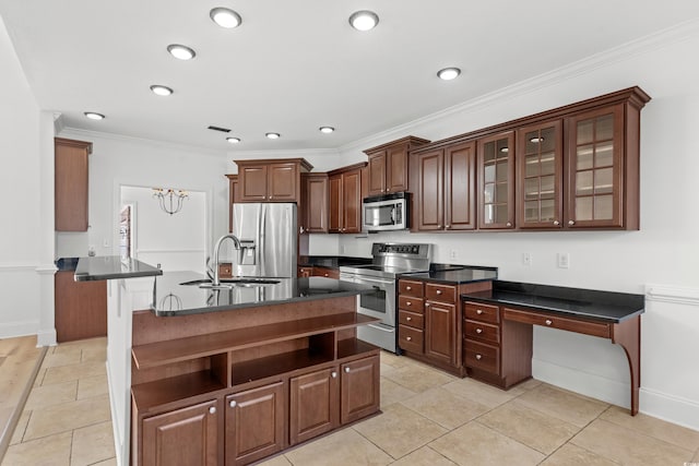 kitchen featuring light tile patterned flooring, sink, ornamental molding, an island with sink, and stainless steel appliances