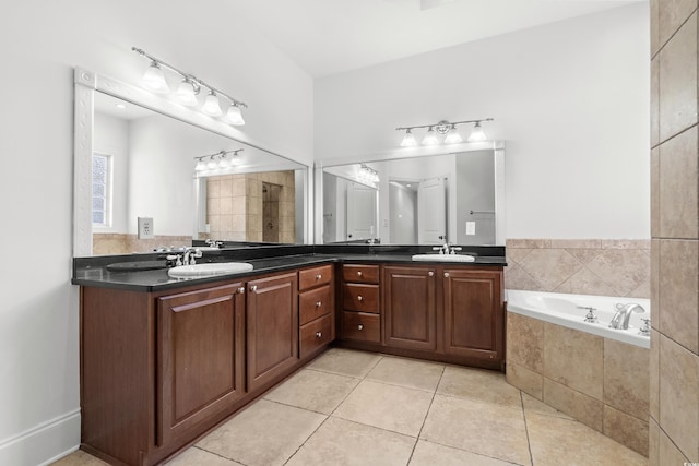 bathroom featuring tile patterned floors, vanity, and plus walk in shower