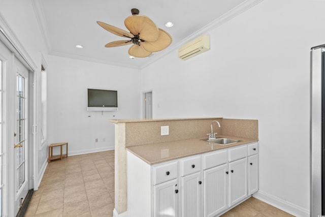 kitchen with crown molding, a wall mounted AC, sink, and white cabinets