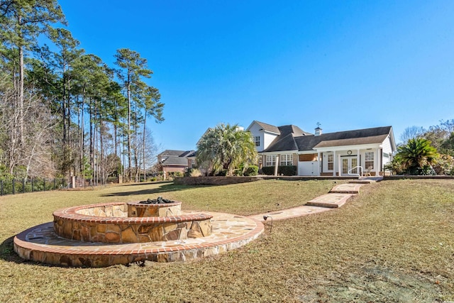 view of yard featuring a fire pit and french doors