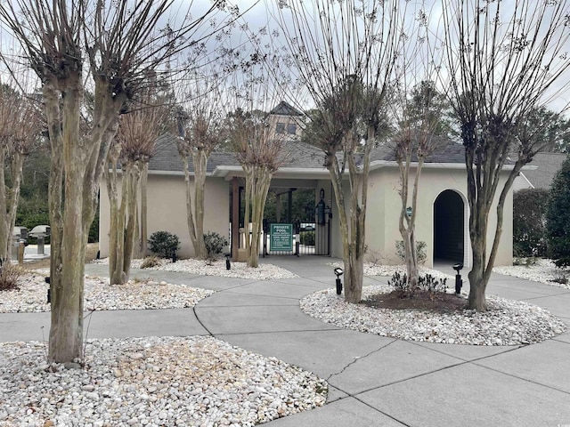 9764 Leyland Dr Unit 7, Myrtle Beach, SC 29572 - obstructed view of property featuring stucco siding and roof with shingles