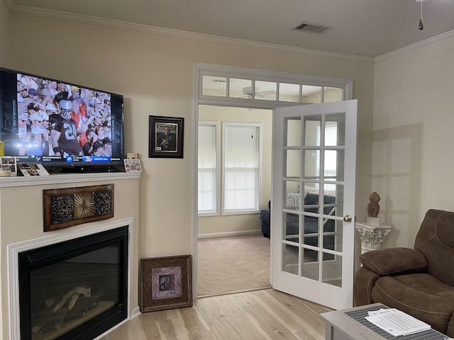 9764 Leyland Dr Unit 7, Myrtle Beach, SC 29572 - living area with wood finished floors, ornamental molding, a glass covered fireplace, and baseboards