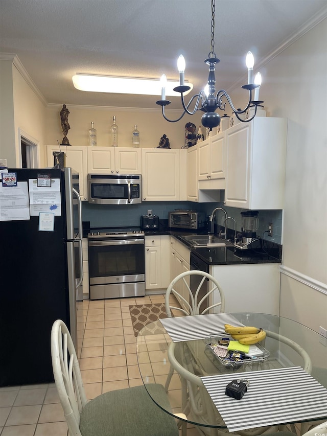 9764 Leyland Dr Unit 7, Myrtle Beach, SC 29572 - kitchen featuring appliances with stainless steel finishes, a sink, crown molding, dark countertops, and light tile patterned floors