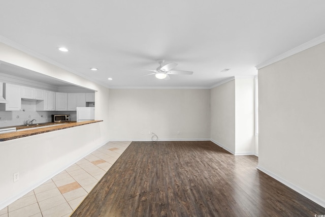 112 Staton Ln, Longs, SC 29568 - unfurnished living room featuring a ceiling fan, recessed lighting, crown molding, and light wood-style flooring