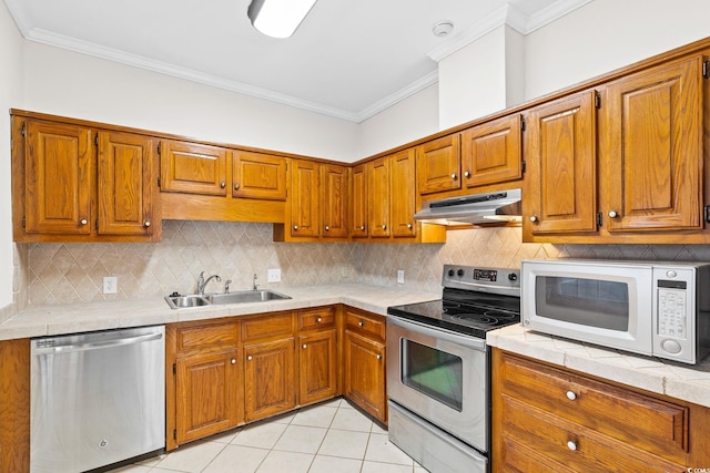 112 Staton Ln, Longs, SC 29568 - kitchen featuring stainless steel appliances, under cabinet range hood, brown cabinetry, ornamental molding, and light tile patterned floors