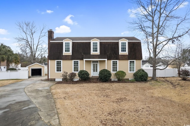 112 Staton Ln, Longs, SC 29568 - colonial inspired home with driveway, a chimney, roof with shingles, an outbuilding, and a detached garage