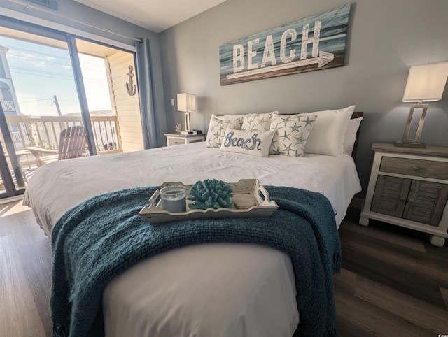 bedroom with wood finished floors and access to exterior